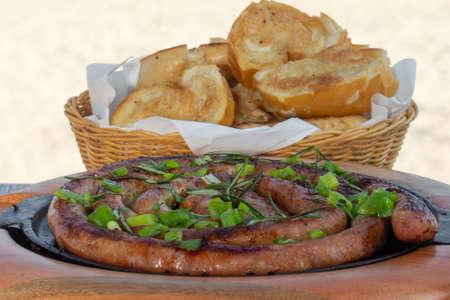 smoked sausage appetizer served with bread toast.