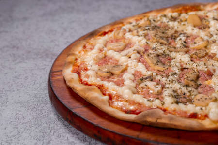 Pizza with Mushroom, ham and catupiry cheese  on gray background. top view.の写真素材