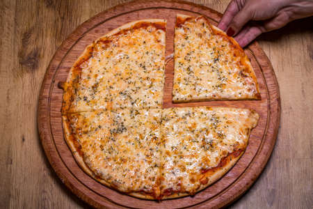delicious mozzarella pizza on wooden background.の写真素材