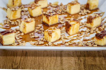 Traditional cheese from Brazil, called Queijo coalho . Served with cane molasses. On wooden table.の写真素材