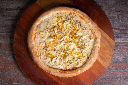 Tasty Mushroom Pizza on wooden background, in Brazil it's called mushroom pizzaの写真素材