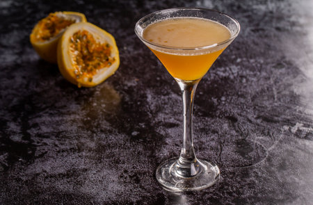 Elegant yellow passion fruit cocktail in martini glassの写真素材