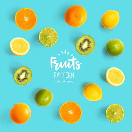 Pattern with kiwi, lime, lemon and orange. Tropical abstract background. Kiwi, lemon and orange on the turquoise background.の写真素材