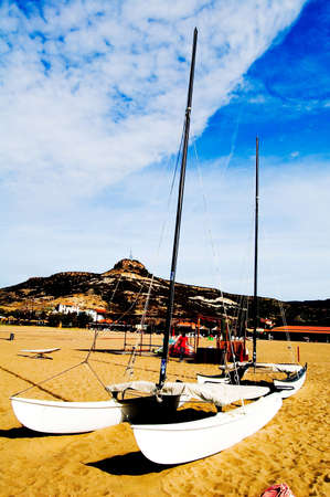 Boats are resting on sand on Sardiniaの写真素材