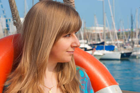 Girl with a lifebuoy on a ship