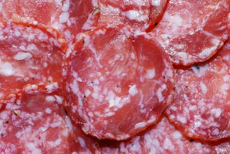 Background with slices of smoked sausageの写真素材