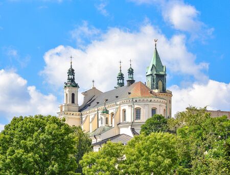 Lublin, Poland - August 10, 2017: Beautiful view of the old church green trees and bright blue sky, old city center. The Metropolitan Cathedral of St. John the Baptist and the Evangelist in Lublin, Polandのeditorial素材