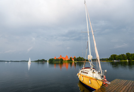 Trakai, Lithuania - August 15, 2017: Little yellow sport yacht on the lake Trakai, Lithuania....
