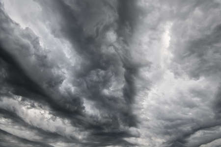 Dark dramatic stormy sky with gray heavy clouds. Perfect for wallpaper, wrapping, fabric,...
