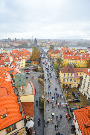 Prague, Czech Republic - October 12, 2017: Ancient Charles Bridge crosses the Vltava river in Prague, Czech Republic. Tourists are walking along Charles Bridge and enjoying the golden autumn and Pragueのeditorial素材