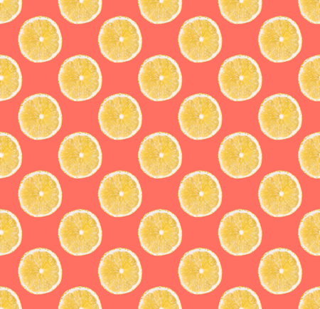 Fresh yellow lemon slices seamless pattern. Close up of citrus fruit slices on bright coral...