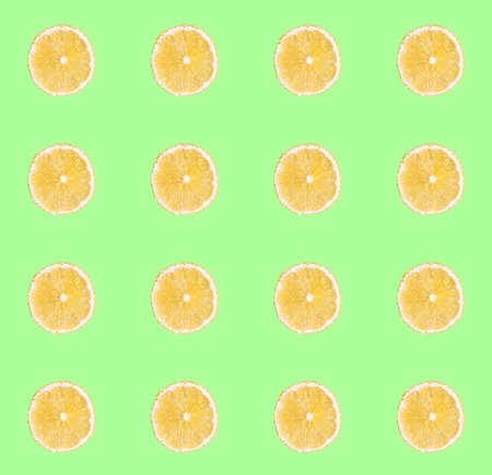 Fresh yellow lemon slices seamless pattern. Close up of citrus fruit slices on pastel green...