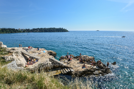 Rovinj, Croatia - May 20, 2018: View on Rovinj central town beach and Adriadic Sea in bright sunny summer day.のeditorial素材