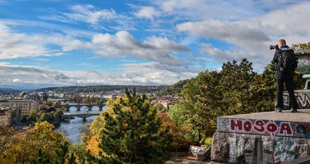 Prague, Czech Republic - October 6, 2017: Photographer takes picture of Gorgeous view on Prague city...