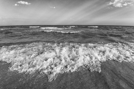 Sea, sand ,sky, waves and summer day. Beautiful tropical beach. Beautiful beach and tropical sea. Seacoast. Black and white photoの写真素材