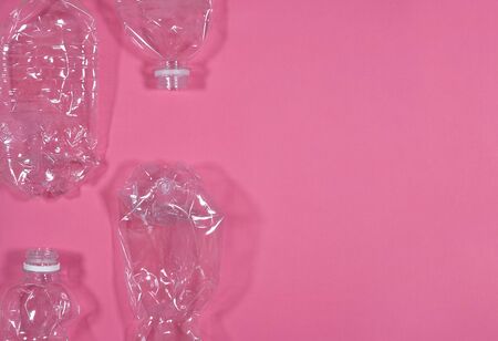 Plastic bottles isolated on pink background. Recycle waste management concept. Plastic Pet Bottles....