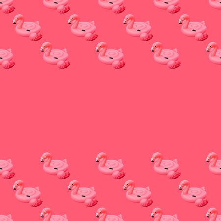 Swimming pool toy in shape of pink flamingo seamless pattern on pink background. Flamingo inflatable cut out. Top view, flat lay with copy space.の写真素材