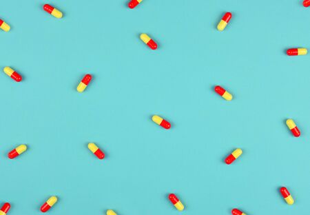 Medical background. Pills pattern on blue background. Flat lay.