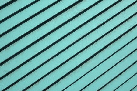 Wooden textured background with diagonal planks. Vintage mint or blue wood background texture with knotsの写真素材