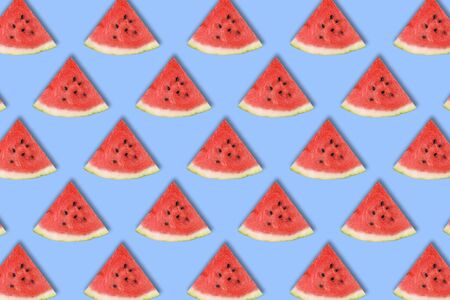 Flat lay of watermelon slices on blue background. Watermelon pattern. Summer fruit. Creative Minimal summer pop art concept.の写真素材