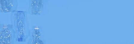 Plastic bottles isolated on deep blue background. Seamless pattern. Recycle waste management concept. Plastic Pet Bottles. Long poster with Copy spaceの写真素材