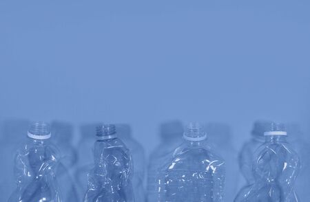 Plastic bottles isolated on deep blue background. Seamless pattern. Recycle waste management concept. Plastic Pet Bottles. Copy spaceの写真素材
