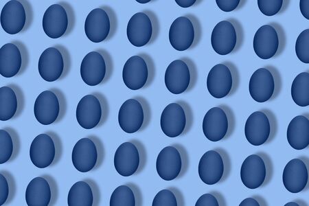 Pattern made of blue eggs on blue background. Minimal food concept. Flat lay, top view. Pop art...