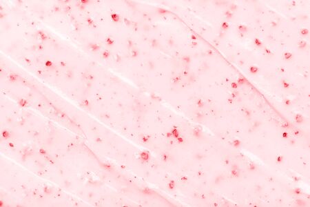 Strawberry ice cream texture close up. Top view. Pink fruit ice cream background with small pieces of berriesの写真素材