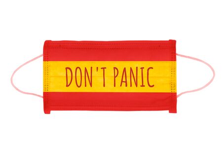 PP non-woven disposable medical face mask isolated on white background. Don't panic lettering on medical mask toned in spain flag colorsの写真素材