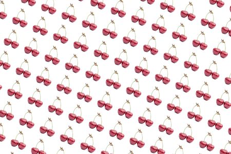 Two cherries berry pattern isolated on a white background. Ripe, tasty red cherries on a white background close up - summer fruits and berries concept. Flat lay.の写真素材