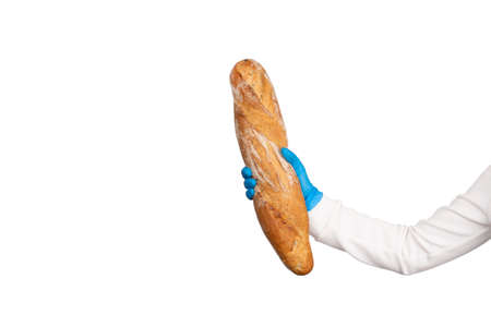 Female hand in blue disposable gloves holds French Baguettes bread. Kitchen and food concept. Banner with copy space.の写真素材