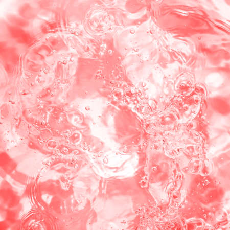 Pool, hot tub water background. Ripples on toned pink in transparent water in swimming pool with...
