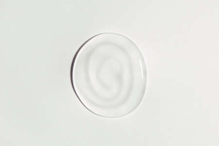 White transparent gel drop isolated on white background. Top view. Virus protection or cosmetics concept. Serum texture close upの写真素材