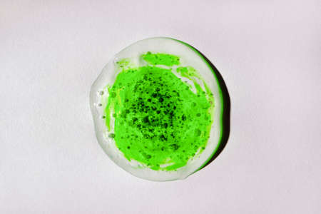 Green and white transparent gel drop isolated on white background. Top view. Virus protection or cosmetics concept. Serum texture close upの写真素材