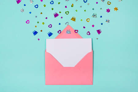 Pink Envelope with party confetti explosion on blue or turquoise background. Invitation card, flat lay. Banner with copy space.の写真素材