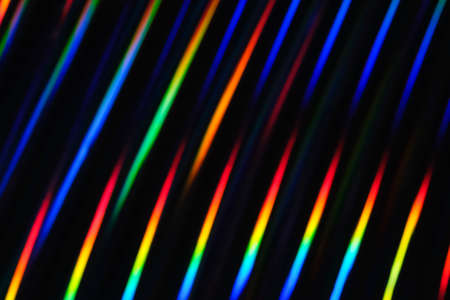 Holographic neon background. Neon rainbow strips on dark background. Soft focus Abstract rainbow color wave strips horizontal background.の写真素材