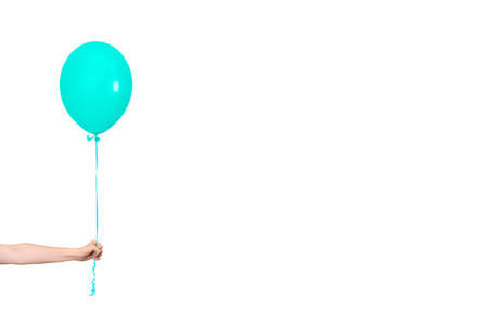 Hand hold blue balloon. Party or present concept. Blue Balloon and hand isolated on white background. Banner with copy space.の写真素材
