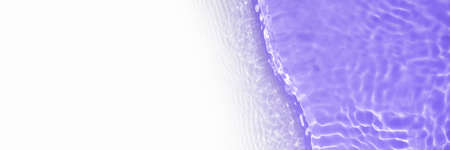 Surface of toned in purple swimming pool water with light reflection and waves. Texture of transparent blue water with waves in swimming pool. Trendy long abstract banner with white copy space.の写真素材