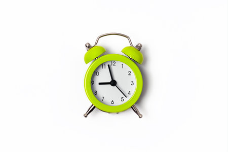 Beautiful lime green metal alarm clock isolated on white background. Concept of time. On the clock...