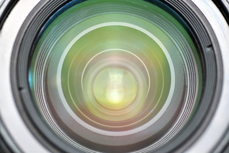 A close-up shot of a camera lens reflecting light in a mesmerizing, circular pattern. Ideal for...