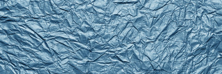 A textured dark blue crumpled paper background with natural creases and folds. Ideal for design projects, digital graphics, or creative presentations requiring a vibrant, Long bannerの写真素材