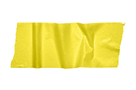 Yellow paper construction scotch, shiny sticky strip of stationery tape, self-adhesive tape isolated on white background. Banner with copy spaceの写真素材
