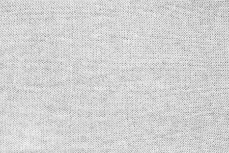 Close up texture of light gray woven fabric with a subtle pattern of evenly spaced tiny dots, providing a soft, neutral background ideal for design and creative projects.の写真素材