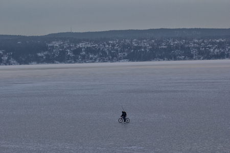 Man cycling on an iceberg on oslofjord norwayの写真素材