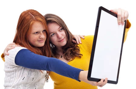 Teen girls making photo with tablet pcの写真素材