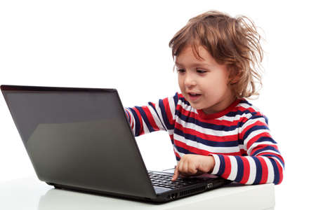 Adorable little boy playing on notebook