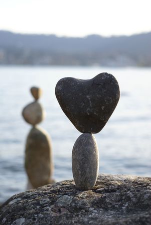 stone heart standing on the another stone      の写真素材