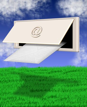letterbox with at symbol on it in front of green grass field and blue skyの写真素材