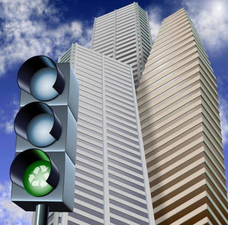 Traffic light with a recycle symbol on it and city skyscrapers in the backgroundの写真素材