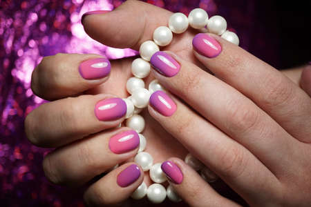 Beautiful bright natural nails with perfect clean manicure. Nail drill machine and cuticle nipper are used simultaneously to make such a clean manicure.の写真素材